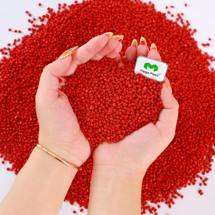 Close-up of red masterbatch pellets, showcasing the uniform dispersion of pigments for consistent color throughout the final product